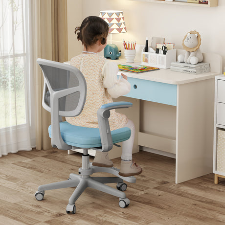 Child sitting at a desk with a chair, surrounded by educational items in a bright room.