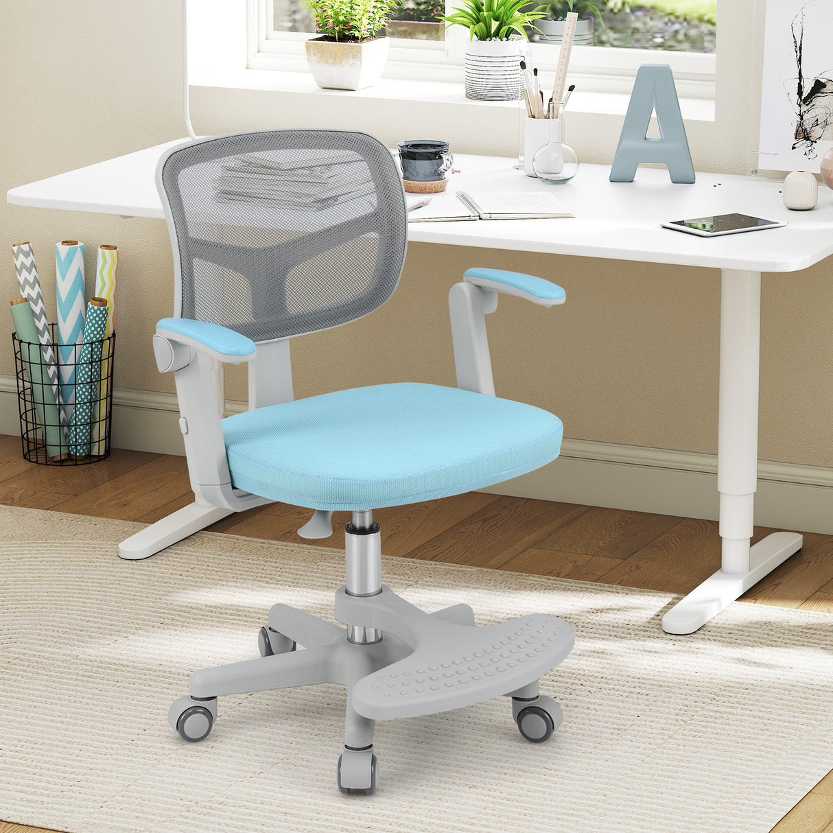Blue office chair in front of a white desk with various items on a wooden floor.