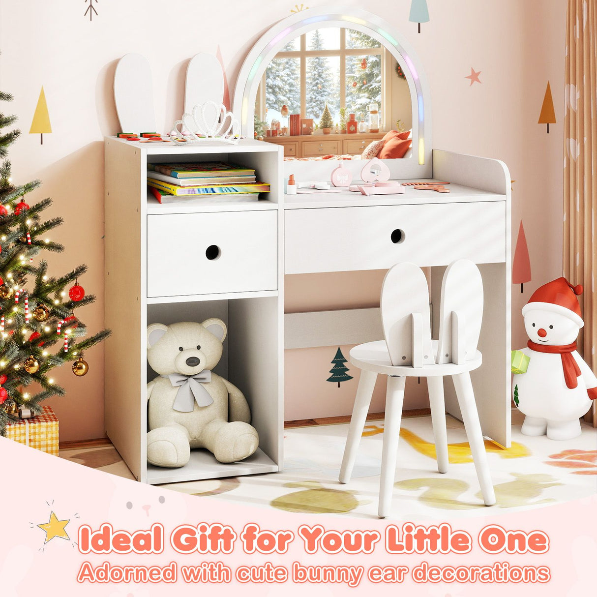 Children's room with a white vanity table, chair, teddy bear, and Christmas tree.