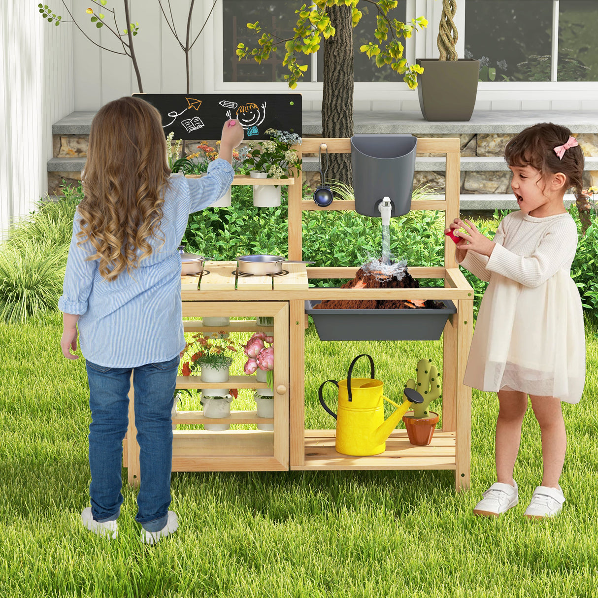 Two children playing with a wooden play kitchen set outdoors.