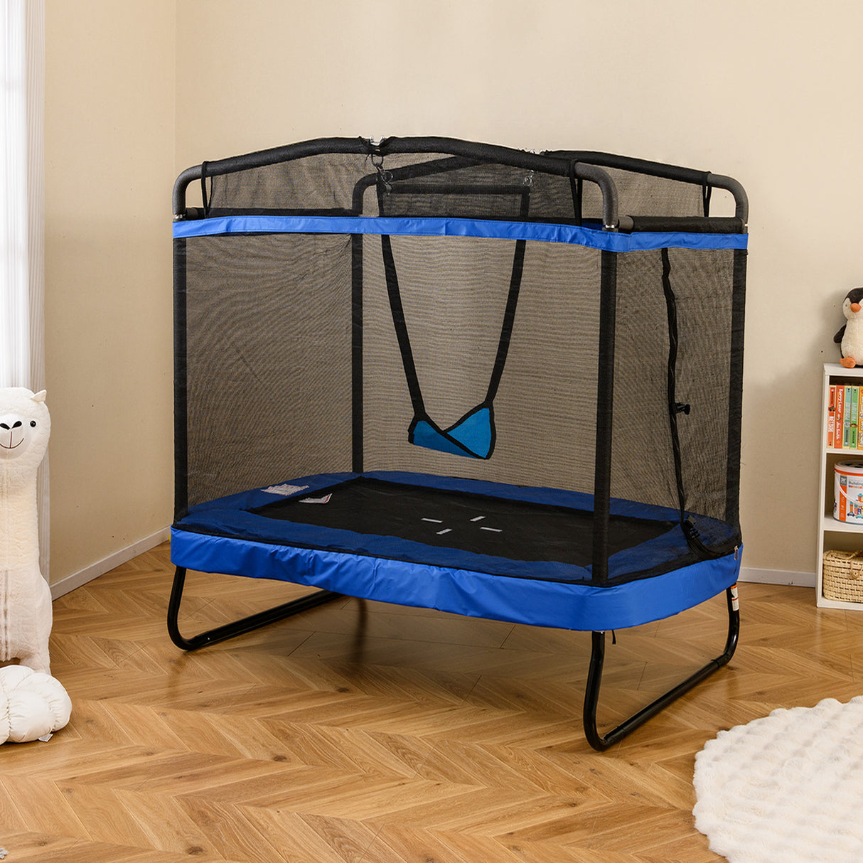 Blue and black trampoline with safety net in a room.