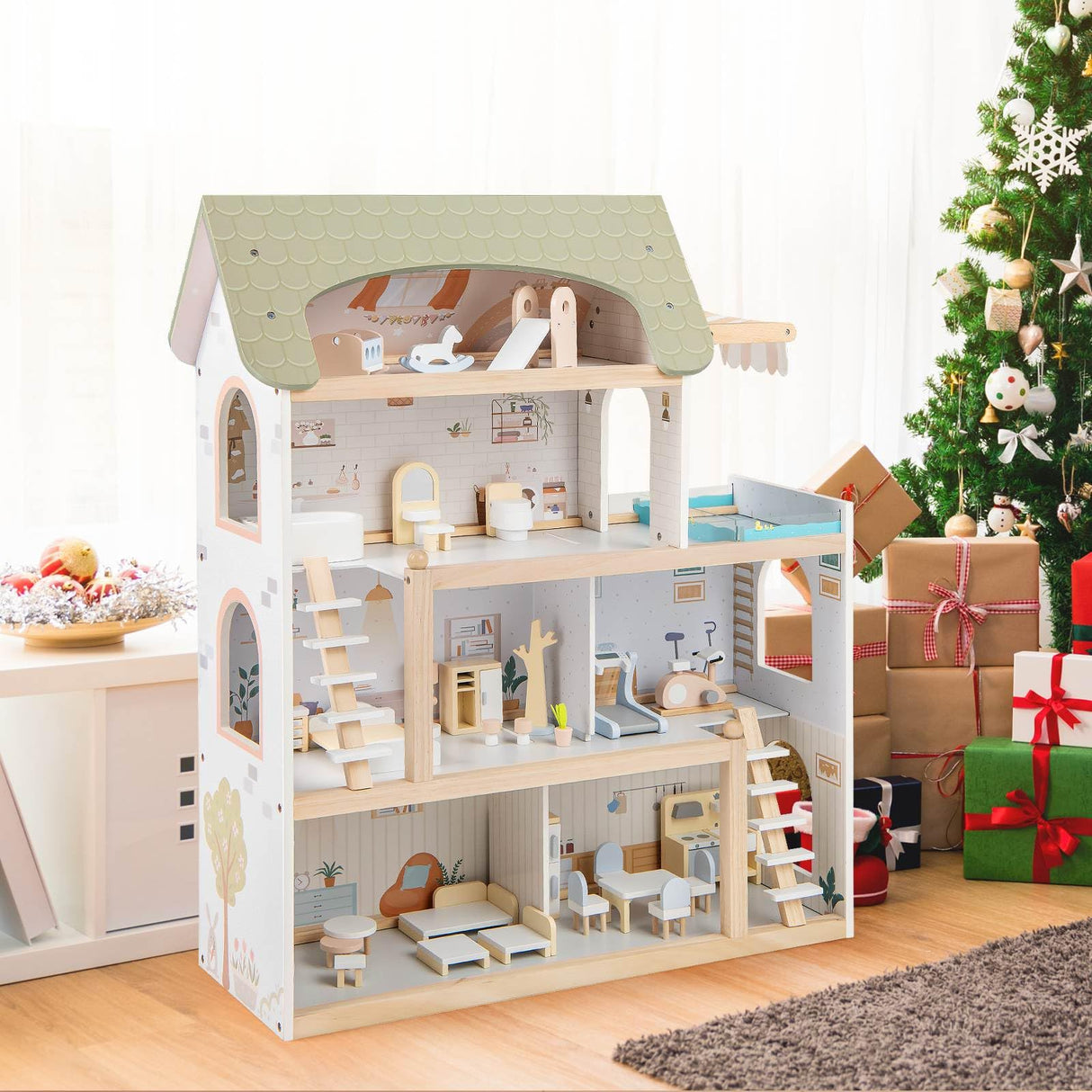 Wooden dollhouse with furniture in a room decorated for Christmas.
