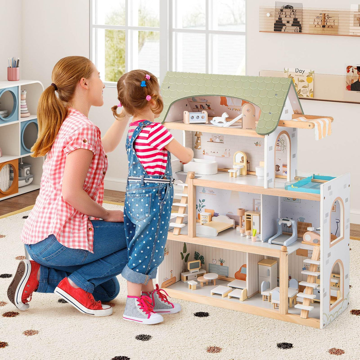 Woman and child playing with a wooden dollhouse in a bright room.