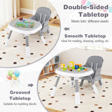 Children's table and chair set with double-sided tabletop on a carpeted floor.