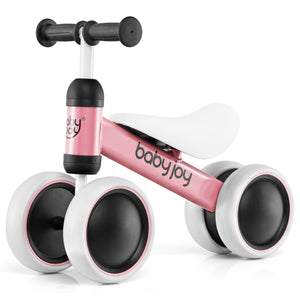 A pink BABY JOY baby balance bike with four wheels, a padded saddle seat, and non-slip handlebars designed for toddlers.