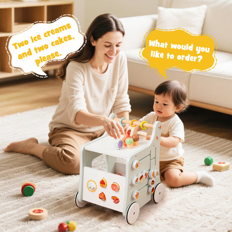 Woman and child playing with a toy cart on a carpeted floor.