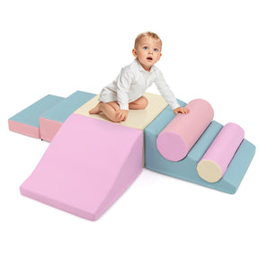 Child playing on a colorful set of soft play blocks.
