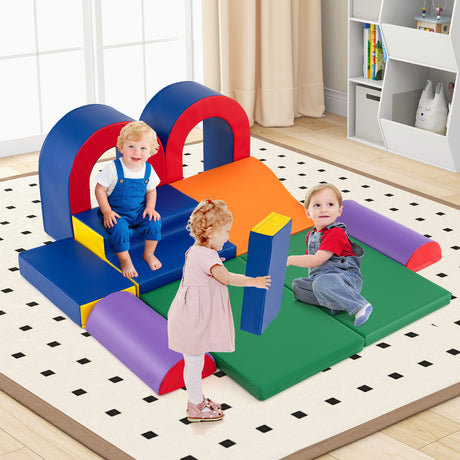 Children playing on a colorful soft play structure in a room with a rug and shelves.