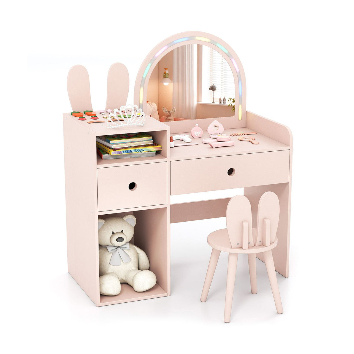 Pink children's vanity table with mirror, chair, and toys on a white background