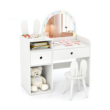White children's vanity table with mirror, chair, and toys on a white background