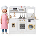 Child in chef's hat and apron standing next to a toy kitchen set on a white background