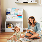 Woman and child sitting on the floor reading books in a room with a bookshelf.