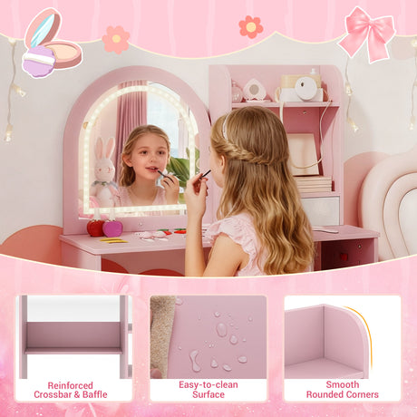 Young girl applying makeup in a pink vanity mirror with various cosmetic items.