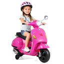 Child sitting on a pink toy scooter with a helmet on a white background