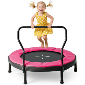 Child in a yellow dress on a pink and black trampoline with a white background