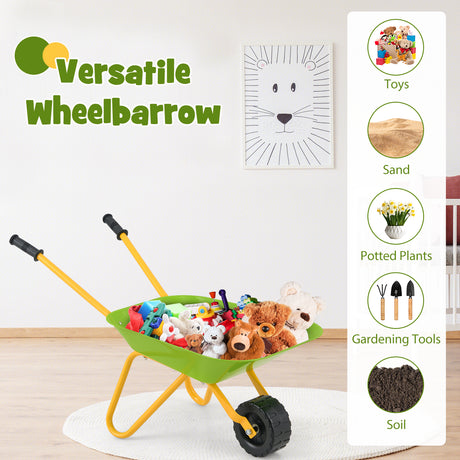 Toy wheelbarrow filled with stuffed animals and toys on a wooden floor.