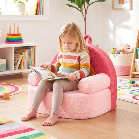 Child sitting on a pink chair reading a book in a colorful room.