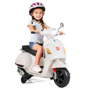 Child sitting on a toy scooter with a helmet on a white background