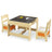 A wooden table with a black chalkboard on top and two chairs, one with a white cushion and one with an orange cushion.
