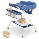 A blue baby changing table with a foldable design, featuring a steel frame, multiple storage compartments, and a water basin beneath the table.