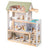 Wooden dollhouse with multiple rooms and furniture on a white background