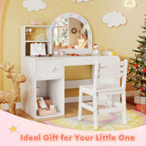 Children's vanity table with mirror and chair in a decorated room with Christmas tree and reindeer.